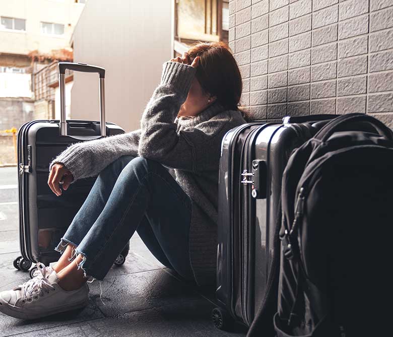 woman-sitting-with-feeling-sad-lost-while-traveling